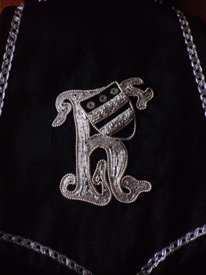 Detail of Hand Embroidered Silver 'h' and the Silver Spangles on the Hungerford Shield