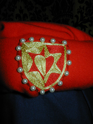 Detail of Heraldry showing Embroidery and Goldwork on Red Silk